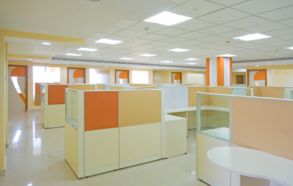 Wide-view open plan office with cream and orange clusters